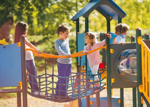 Children playing together on a climbing frame in a playground
