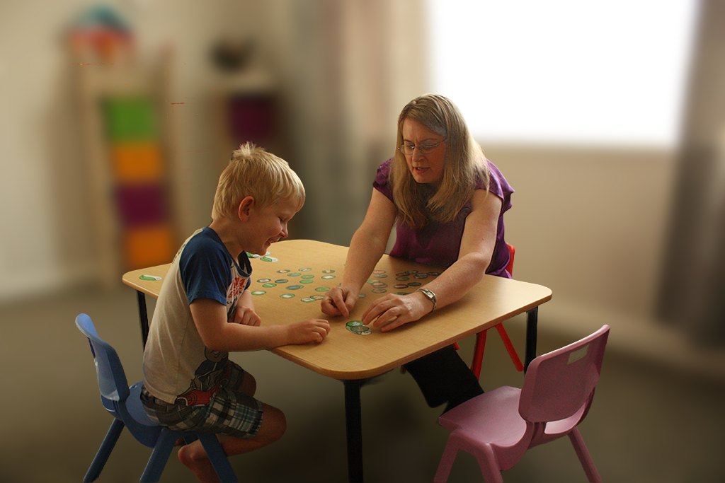 Sarah and a young boy working together at a low table